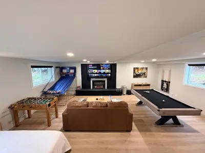 a large living room with a pool table and ping pong at Huge Private Suite with Pool Table, Sauna & Fire Pit in Ellenville