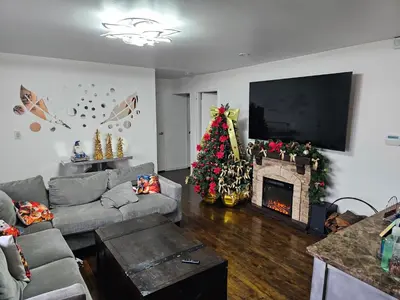 a living room with a christmas tree and a couch at Clientele in North Bergen