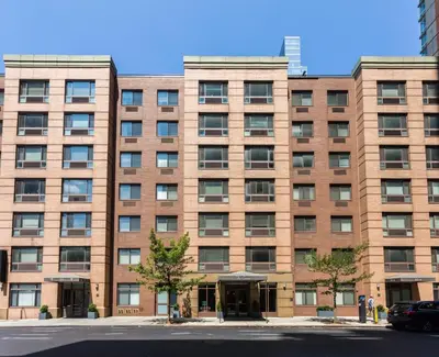 a large brick building with a car parked in front at Cameo in New York