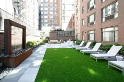 a patio with chairs and grass on a building at Cameo in New York
