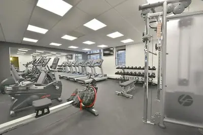 a gym with rows of treadmills and machines at Cameo in New York