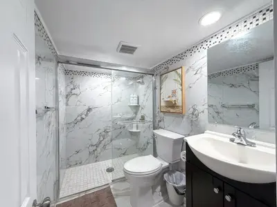 a bathroom with a toilet and a sink and a shower at South Philly Retreat with Movie Nights and Backyard BBQ in Philadelphia