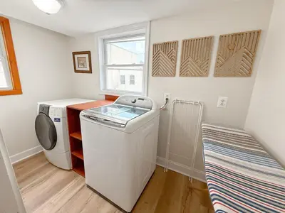 a laundry room with a washing machine and a window at South Philly Retreat with Movie Nights and Backyard BBQ in Philadelphia