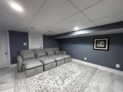 a living room with a couch and a rug at South Philly Retreat with Movie Nights and Backyard BBQ in Philadelphia