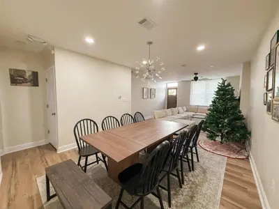 a dining room with a table and a christmas tree at South Philly Retreat with Movie Nights and Backyard BBQ in Philadelphia