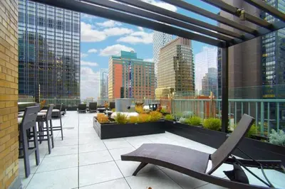 a rooftop patio with chairs and a view of a city at Executive Plaza in New York