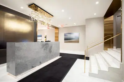 a lobby with a reception desk and stairs at Executive Plaza in New York