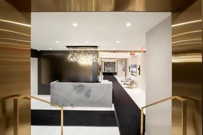 a lobby of a hotel with a chandelier at Executive Plaza in New York