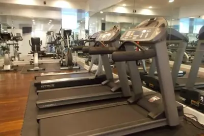 a gym with rows of treadmills and machines at Executive Plaza in New York