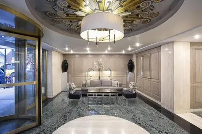 a living room with a couch and a chandelier at Executive Plaza in New York
