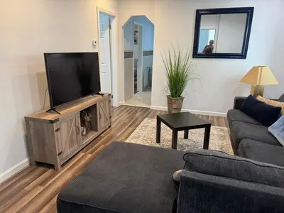 a living room with a couch and a tv at Lovely 2Bed in Newark in Newark