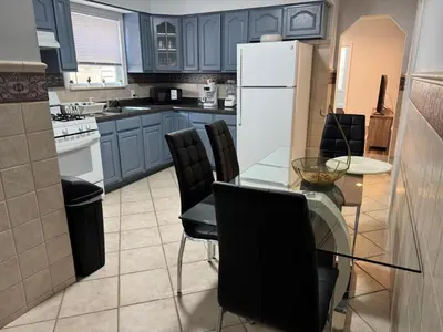 a kitchen with a glass table and black chairs at Lovely 2Bed in Newark in Newark
