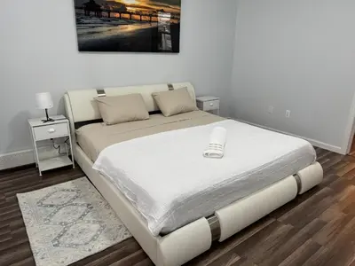 a bed in a room with a white bed frame at Lovely 2Bed in Newark in Newark