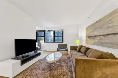 a living room with a couch and a tv at Nash in New York