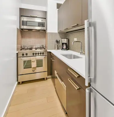 a kitchen with a stove and a sink at Nash in New York