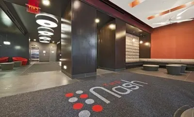 an office lobby with a boss carpet on the floor at Nash in New York
