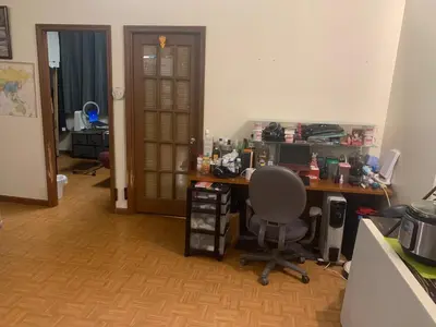 an office with a desk and a chair in a room at Near Seaport In Chinatown in New York