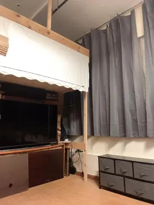 a living room with a tv and a large window at Near Seaport In Chinatown in New York