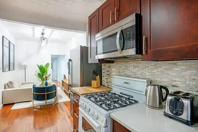a kitchen with a stove and a microwave at Prime location 1BR Newly Furnished in New York