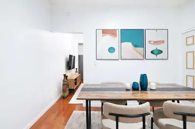 a dining room with a table and chairs at Prime location 1BR Newly Furnished in New York