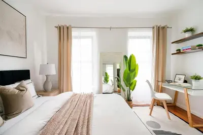 a bedroom with a large white bed and a desk at Prime location 1BR Newly Furnished in New York