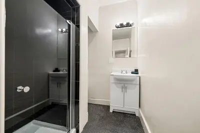 a bathroom with a shower and a sink at FIFA26|Based Btwn MetLife & Manhattan|Parking in Bayonne