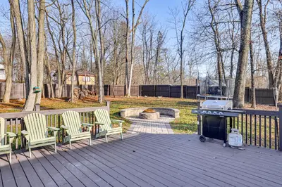 a grill on a deck with two chairs and a fire place at Pet-Friendly Group Getaway 12 Mi to Camelback Mtn! in Cresco
