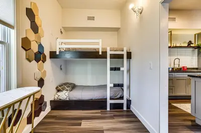 a small room with bunk beds and a kitchen at Pet-Friendly Group Getaway 12 Mi to Camelback Mtn! in Cresco