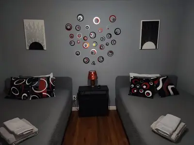 a living room with a couch and a clock on the wall at 2 Beds - Work & Study - NYC - EWR - Walk to Train in East Newark