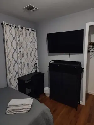 a bedroom with a bed and a flat screen tv at 2 Beds - Work & Study - NYC - EWR - Walk to Train in East Newark