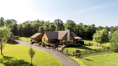 an aerial view of a house with a horse and a driveway at Luxurious Log Cabin with Game Room & Fireplace near Princeton in New Hope, Pennsylvania in New Hope