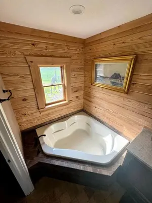 a large white tub in a room with a window at Luxurious Log Cabin with Game Room & Fireplace near Princeton in New Hope, Pennsylvania in New Hope