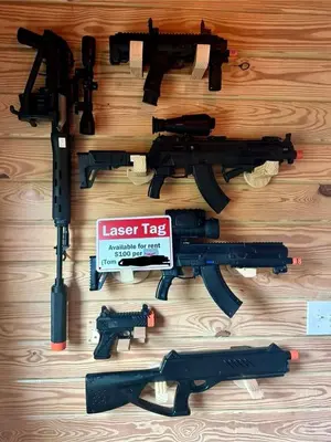 a group of toy guns on a wooden table at Luxurious Log Cabin with Game Room & Fireplace near Princeton in New Hope, Pennsylvania in New Hope