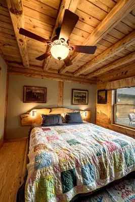a bedroom with a bed with a ceiling fan at Luxurious Log Cabin with Game Room & Fireplace near Princeton in New Hope, Pennsylvania in New Hope