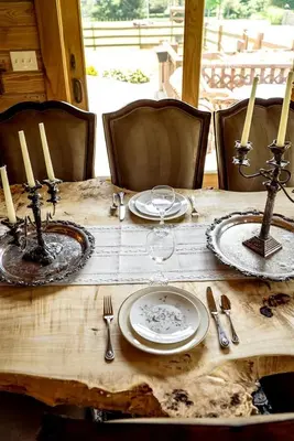 a wooden table with plates and utensils on it at Luxurious Log Cabin with Game Room & Fireplace near Princeton in New Hope, Pennsylvania in New Hope