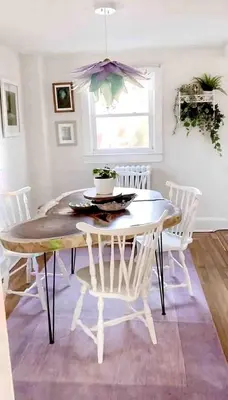 a dining room with a table and white chairs at Charming Historic Riverfront Home with Garden Views near Lambertville, New Jersey in Titusville
