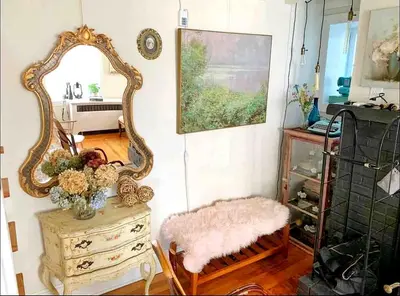 a mirror sitting on top of a dresser in a room at Charming Historic Riverfront Home with Garden Views near Lambertville, New Jersey in Titusville