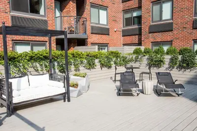 a gazebo with a couch and chairs on a patio at Central Chelsea 1BR w Gym Doorman NYC-20 in New York