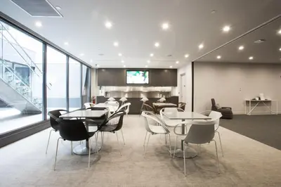 a dining room with tables and chairs and a television at Central Chelsea 1BR w Gym Doorman NYC-20 in New York