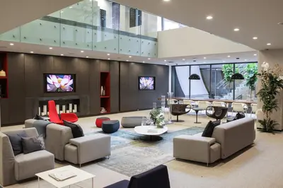a large living room with couches and a tv at Central Chelsea 1BR w Gym Doorman NYC-20 in New York