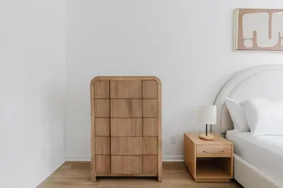a bedroom with a wooden book shelf next to a bed at Blueground Alphabet City washer nr Tompkins Square Park NYC-2160 in New York