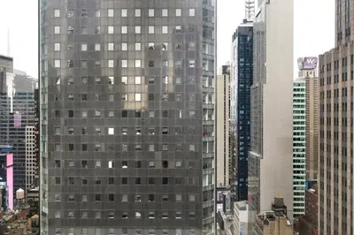 a tall building in a city with tall buildings at Blueground Midtown South rooftop nr Bryant Park NYC-2031 in New York