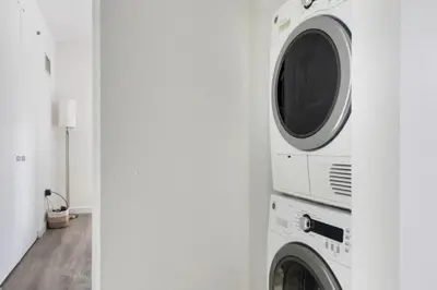 a laundry room with a washer and dryer at Blueground Midtown South rooftop nr Bryant Park NYC-2031 in New York