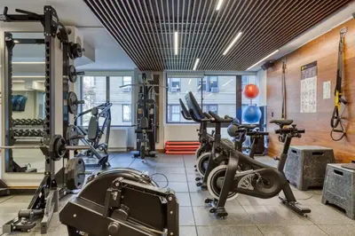 a gym with several treadmills and cardio machines at Blueground Upper West Side fitness nr Central Park NYC-1993 in New York