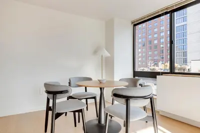 a room with a table and chairs and a window at Blueground Upper West Side fitness nr Central Park NYC-1993 in New York