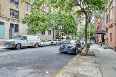a street with cars parked on the side of the road at Blueground Upper West Side fitness nr Central Park NYC-1993 in New York