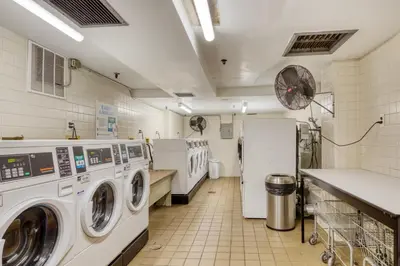 a laundry room with washers and dryers in it at Chelsea 1BR w Water views Doorman NYC-210 in New York