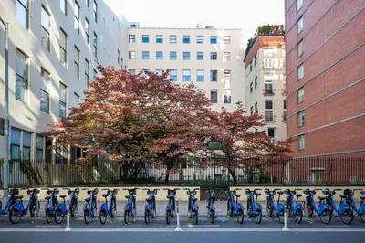 a row of blue bikes parked in a parking lot at Chelsea 1BR w Water views Doorman NYC-210 in New York