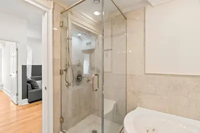 a glass shower in a bathroom with a tub at Apartmint at 113 Chestnut - Philadelphia in Philadelphia