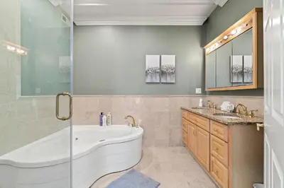 a bathroom with a tub and two sinks and a shower at Apartmint at 113 Chestnut - Philadelphia in Philadelphia